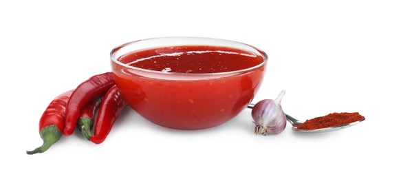 Photo of Spicy chili sauce in bowl and ingredients isolated on white