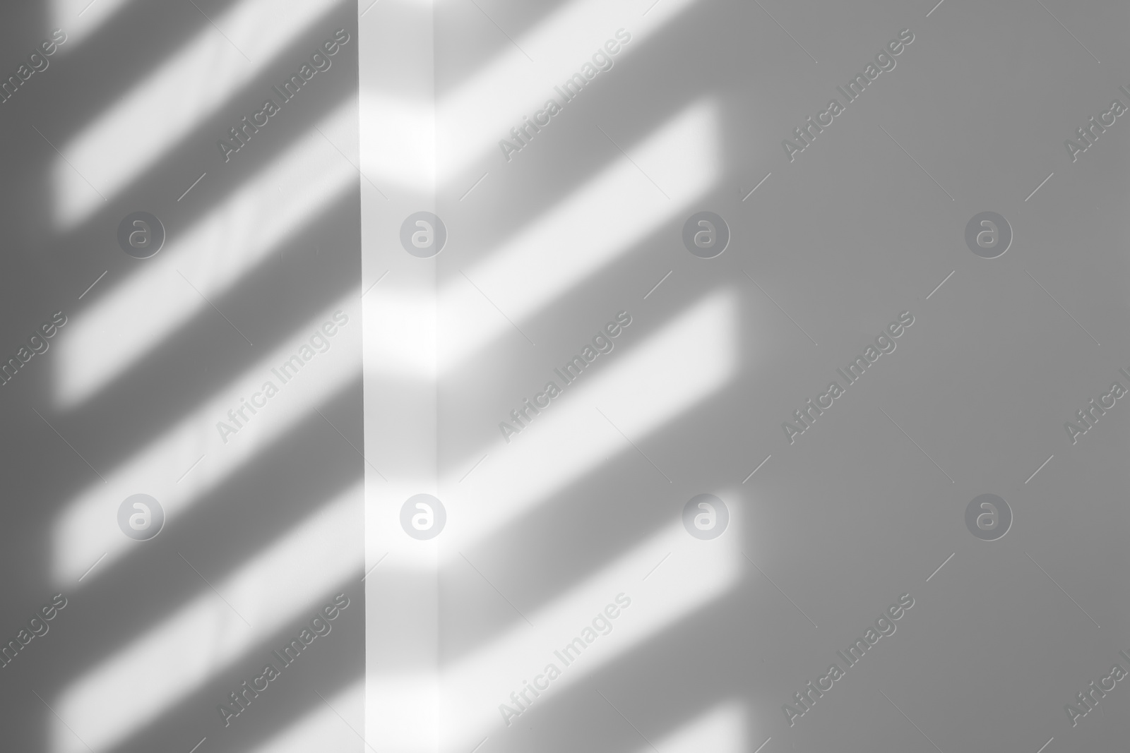 Photo of Lines made of light and shadows on white wall