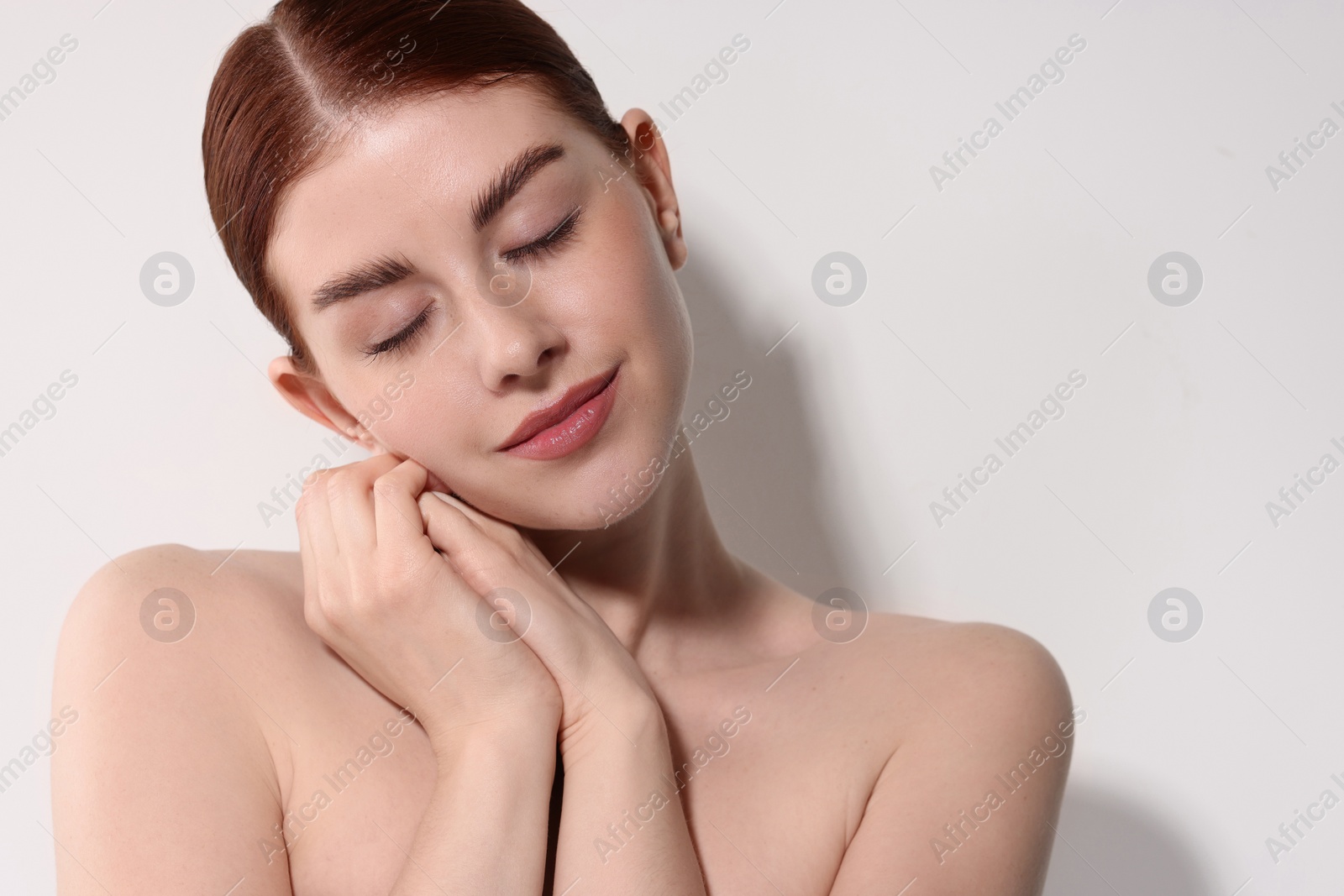 Photo of Portrait of beautiful woman on light background