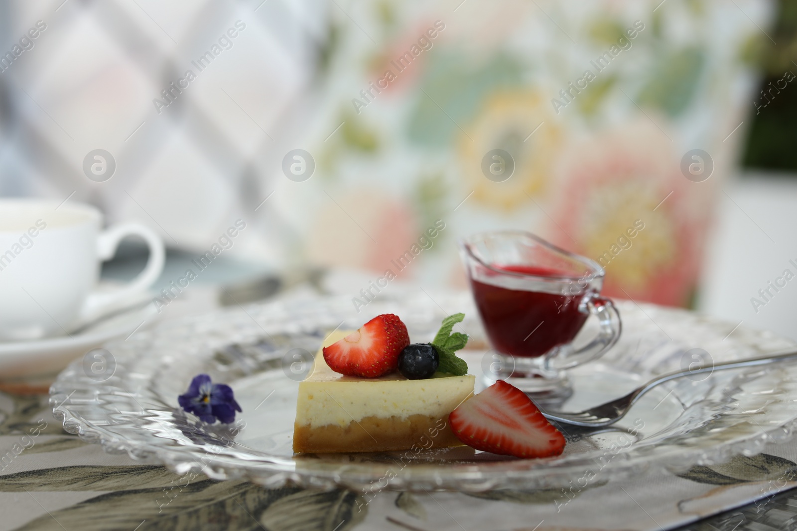 Photo of Slice of delicious cheesecake with fresh berries served on table in restaurant, closeup. Space for text