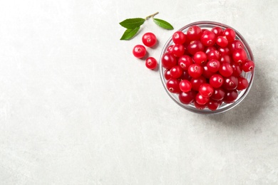 Photo of Fresh cranberry on light table, flat lay. Space for text