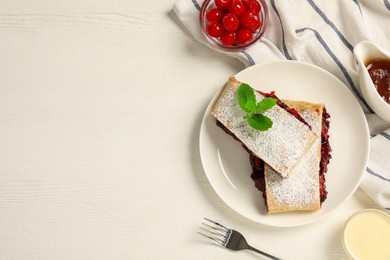 Photo of Delicious strudel with cherries, powdered sugar and mint served on white wooden table, flat lay. Space for text