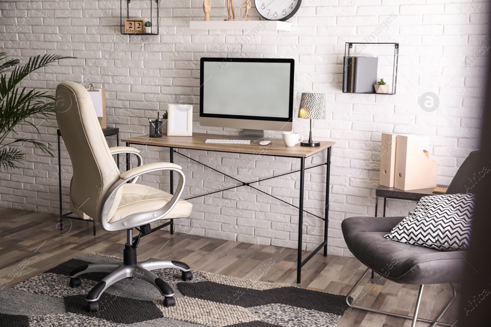 Photo of Comfortable chair near desk in modern office interior