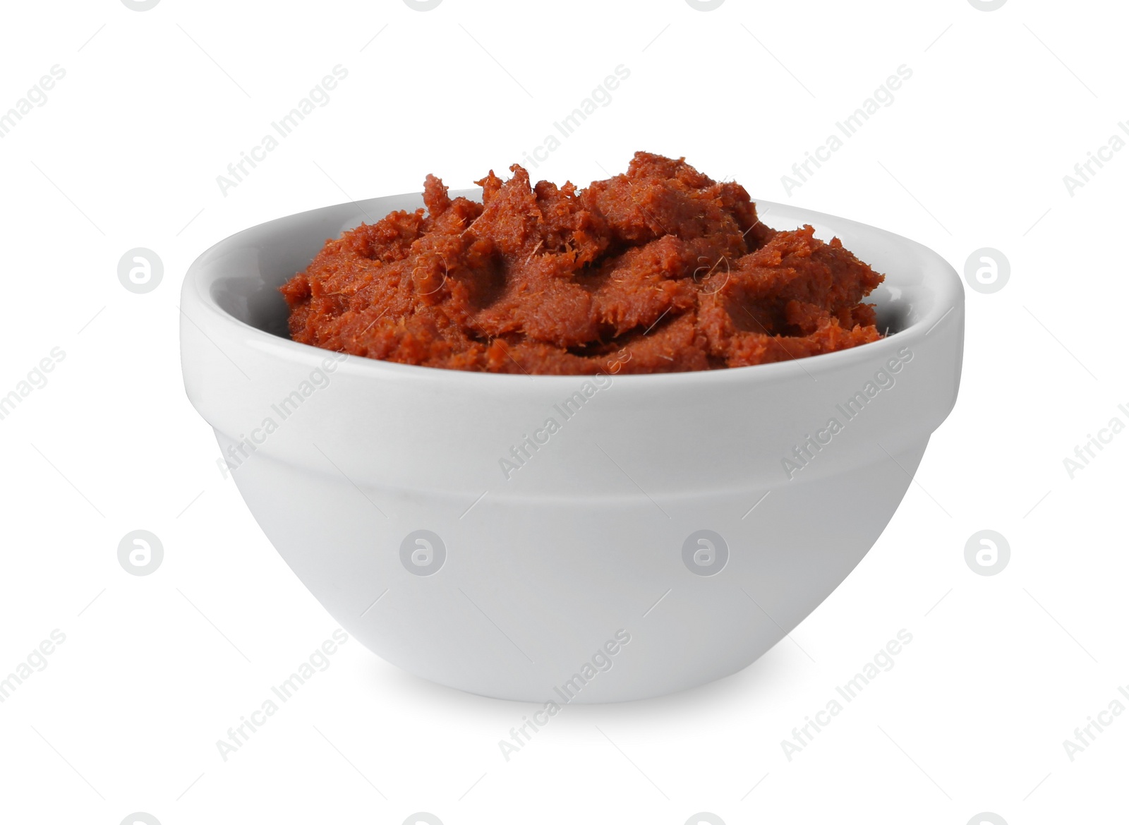 Photo of Tasty curry paste in bowl isolated on white