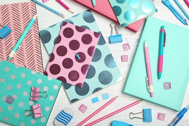 Flat lay composition with different school stationery on wooden background