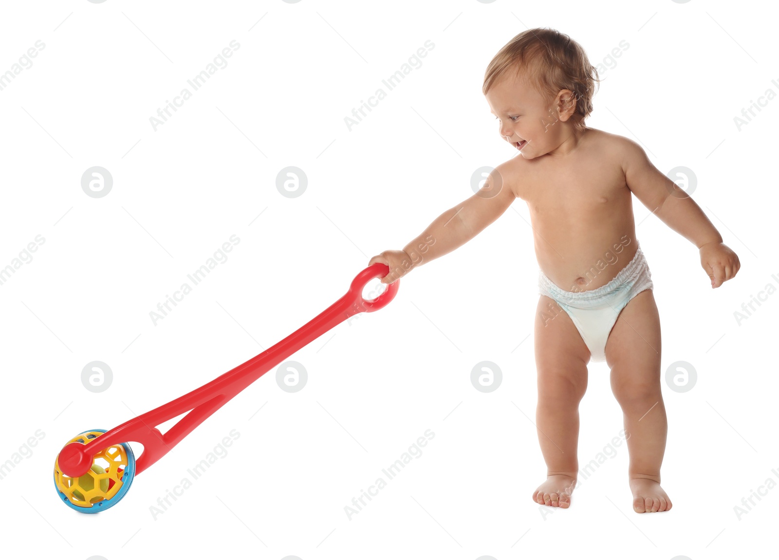 Photo of Cute baby with push toy learning to walk on white background