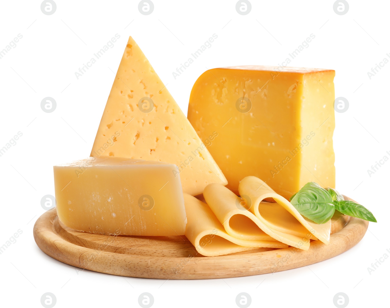 Photo of Wooden board with different kinds of cheese and basil on white background