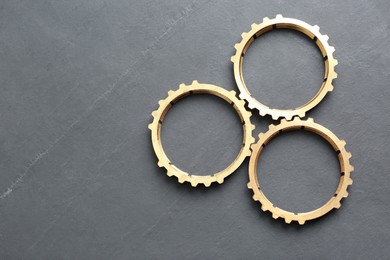 Photo of Stainless steel gears on grey background, flat lay. Space for text