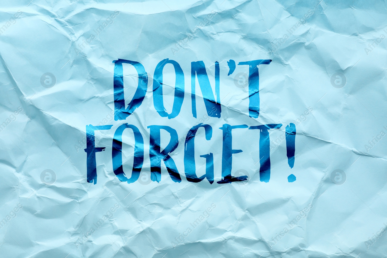 Image of Phrase Don;t forget written on crumpled blue paper