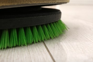 Photo of Modern polishing machine on parquet floor, closeup