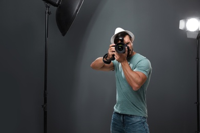 Photo of Professional photographer taking picture in modern studio
