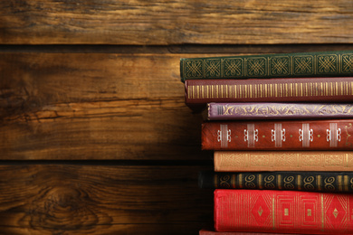 Photo of Collection of different books on wooden background. Space for text