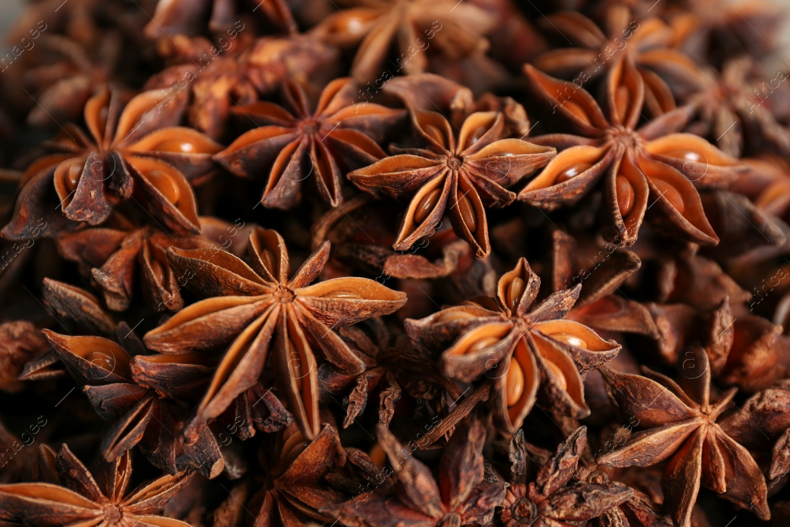 Photo of Aromatic anise stars as background, closeup view