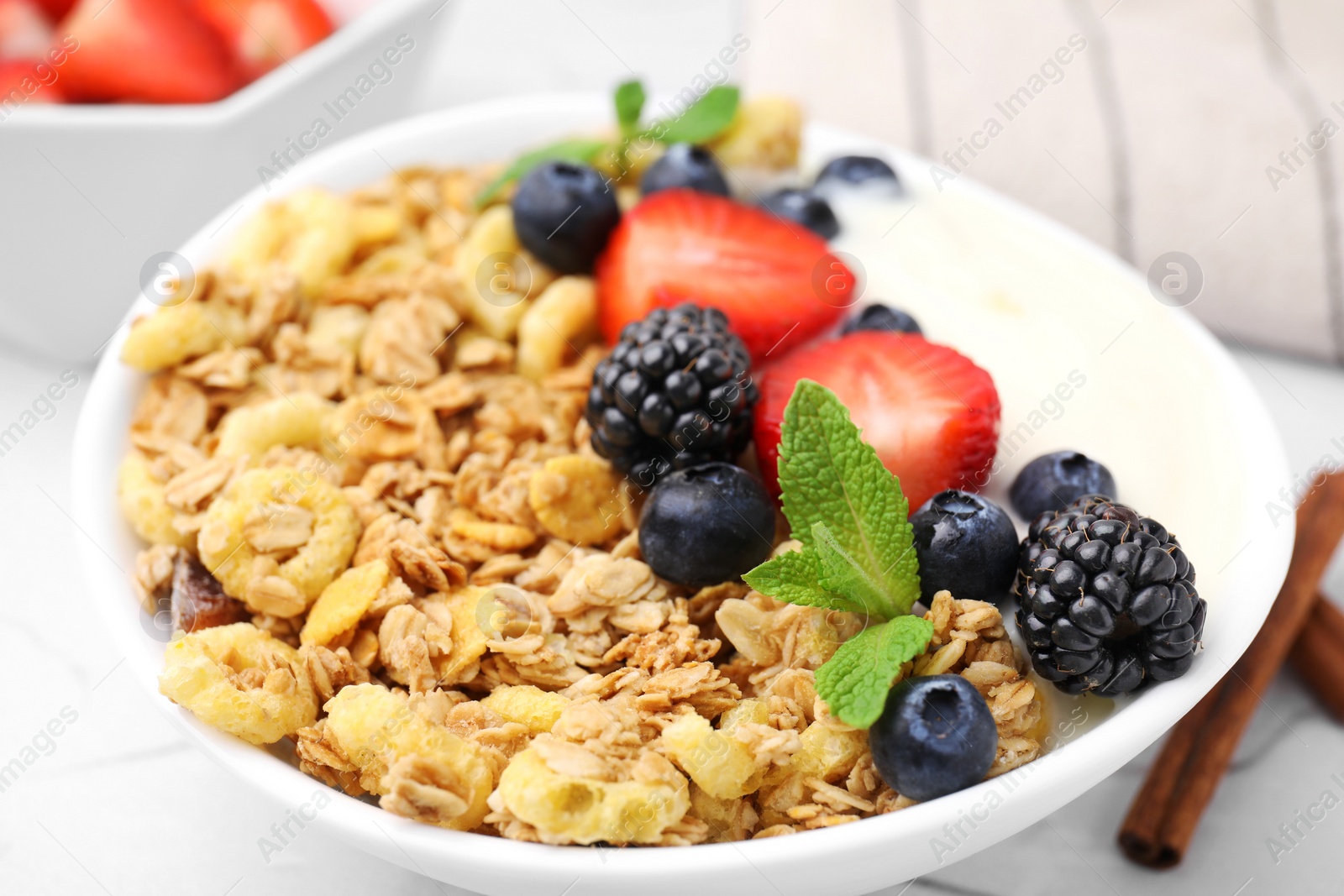 Photo of Tasty oatmeal, yogurt and fresh berries in bowl, closeup. Healthy breakfast