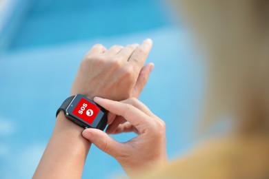 Image of Woman using SOS function on smartwatch outdoors, closeup