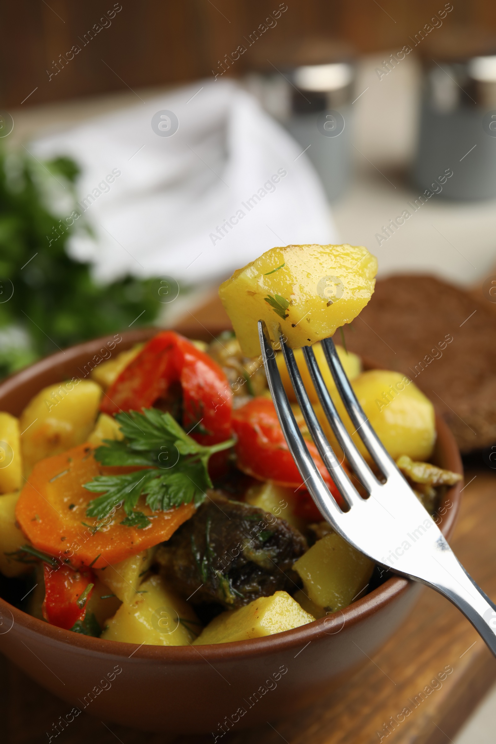 Photo of Tasty cooked dish with potatoes in earthenware, closeup