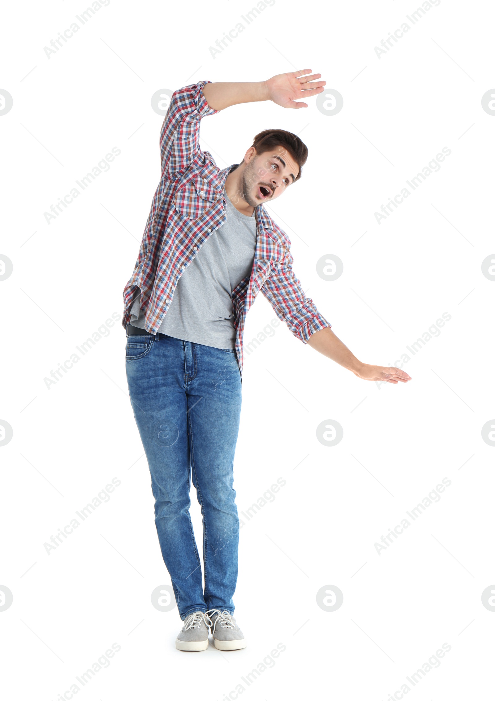 Photo of Young man attracted to magnet on white background