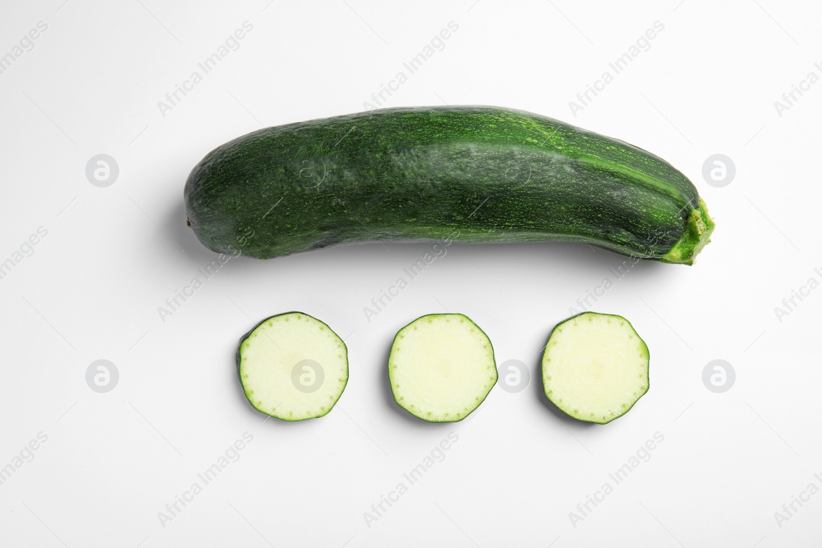 Photo of Fresh ripe green zucchinis on white background, top view