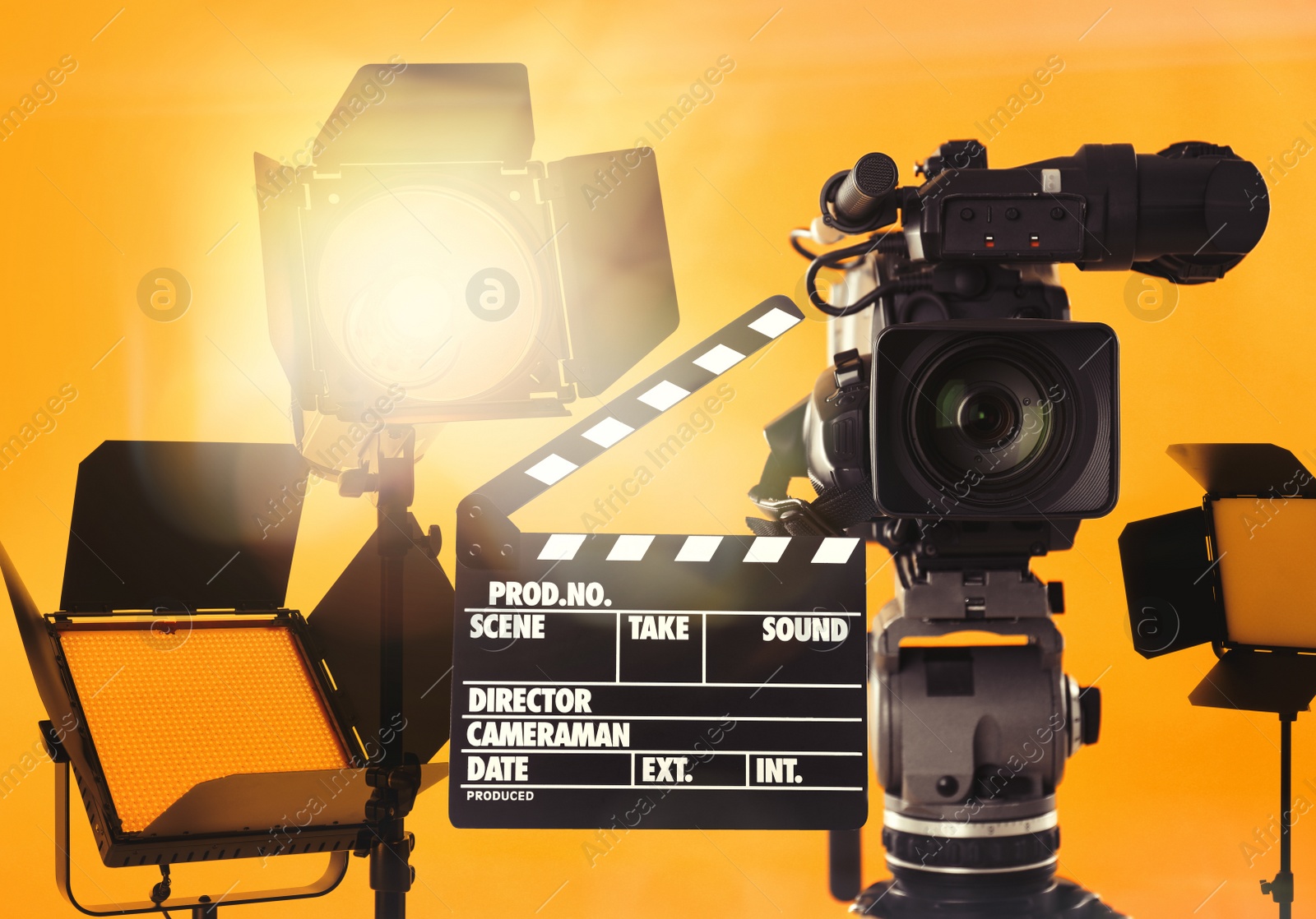 Image of Modern professional video camera and lighting equipment in studio