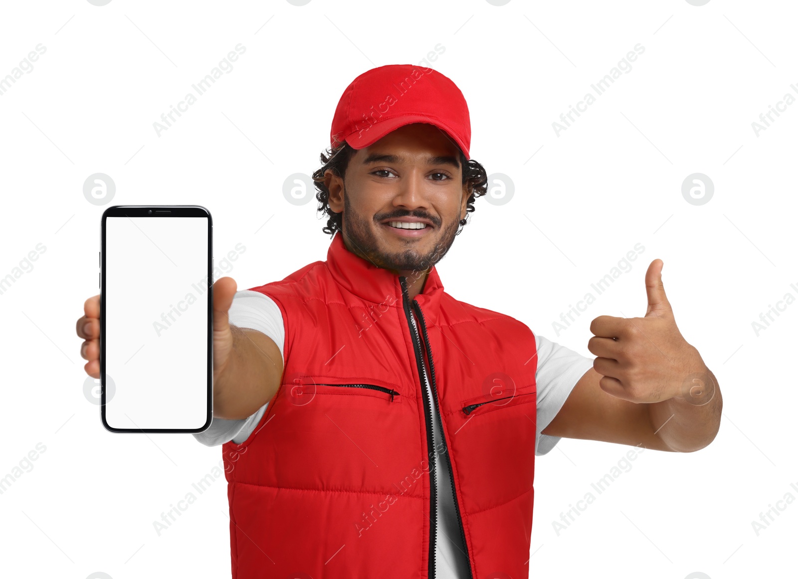 Image of Happy courier holding smartphone with empty screen and showing thumbs up on white background