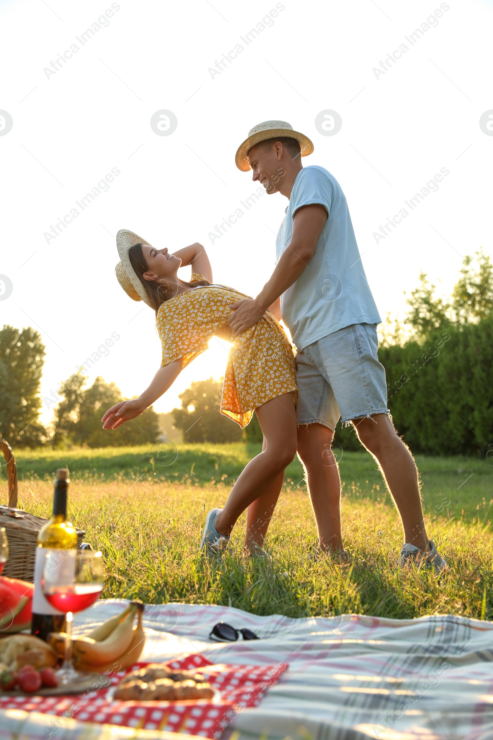 Photo of Happy couple dancing on picnic in park