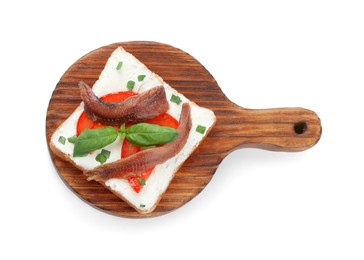 Delicious sandwich with cream cheese, anchovies, tomatoes and basil on white background, top view