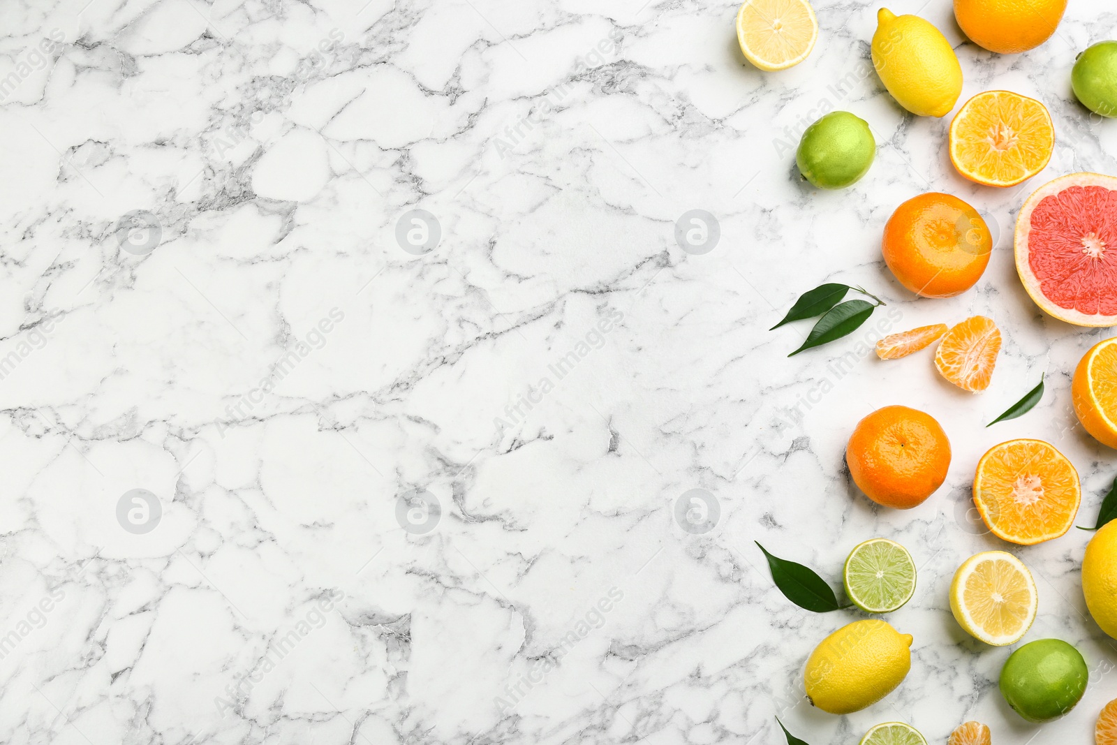 Photo of Flat lay composition with tangerines and different citrus fruits on white marble background. Space for text