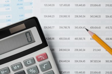 Photo of Calculator and pencil on documents with financial calculations, flat lay