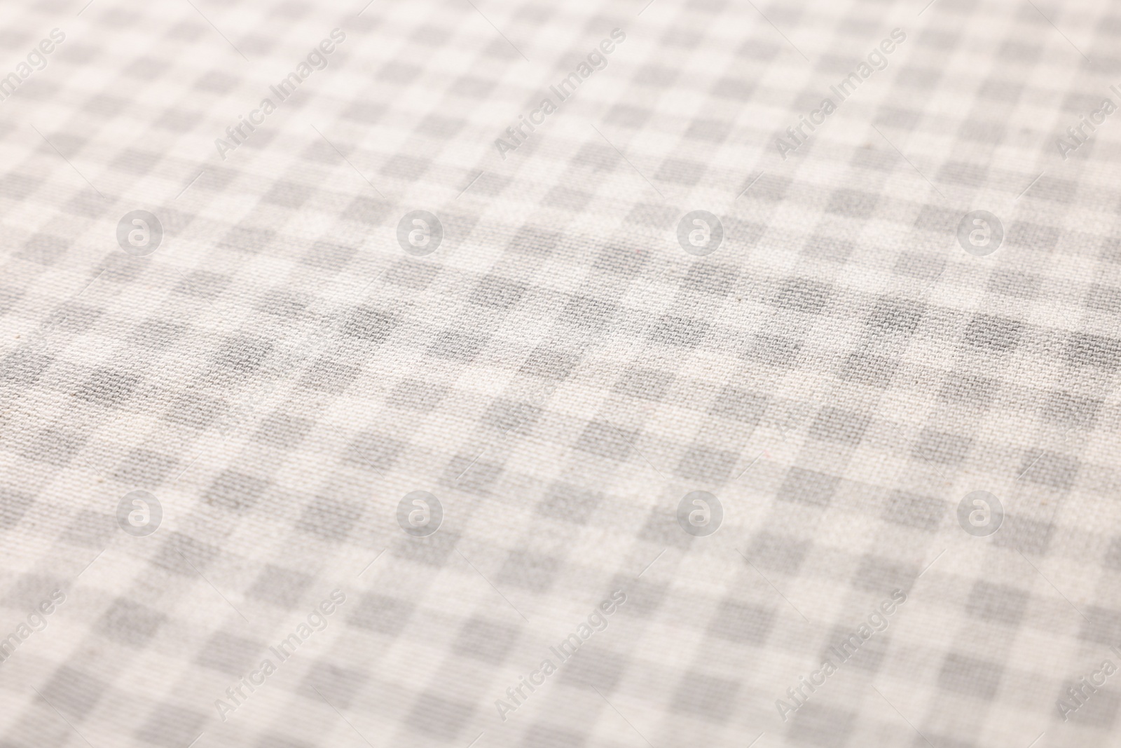 Photo of Beige checkered tablecloth as background, closeup view