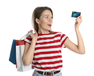 Photo of Young woman with credit card and shopping bags on white background. Spending money