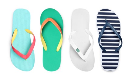 Set with different flip flops on white background, top view