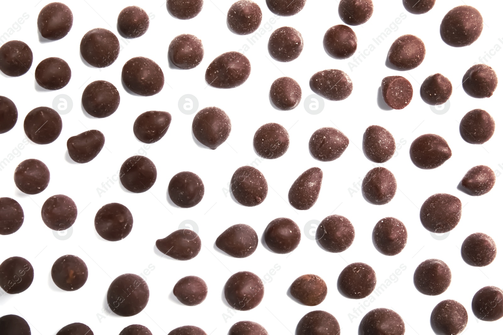 Photo of Delicious dark chocolate chips on white background, flat lay