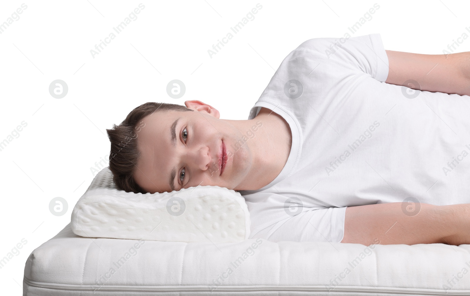 Photo of Man lying on orthopedic pillow against white background