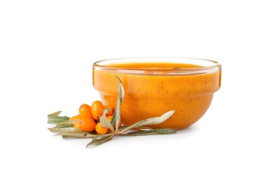 Delicious sea buckthorn jam in bowl and fresh berries on white background