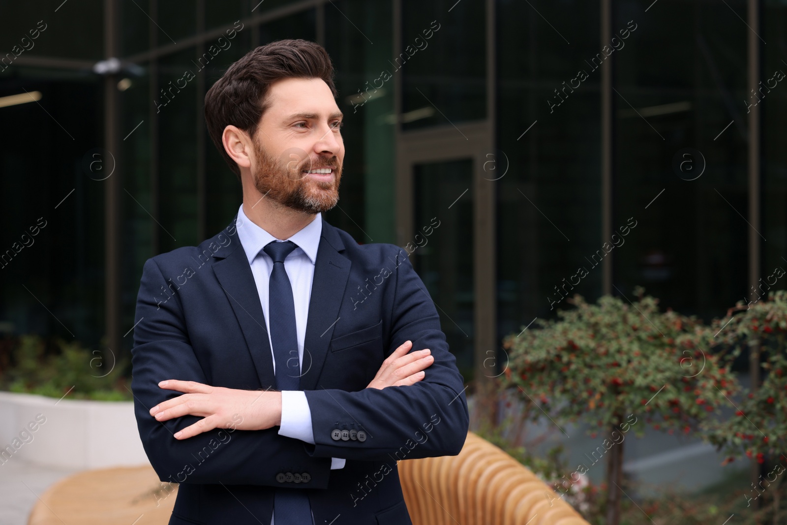 Photo of Male real estate agent outdoors. Space for text