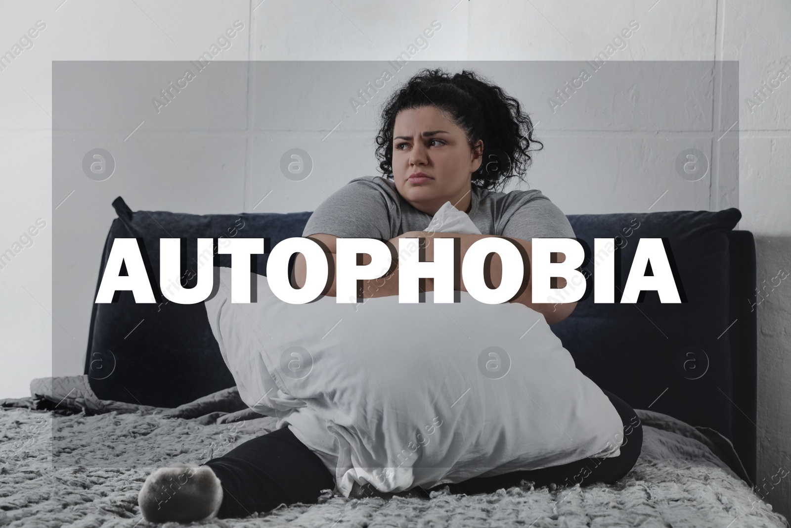 Image of Depressed overweight woman sitting alone on bed at home. Autophobia - fear of isolation