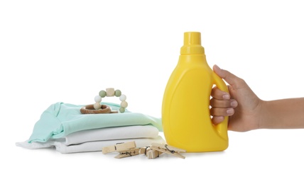 Photo of Woman with detergent and children's clothes on white background, closeup