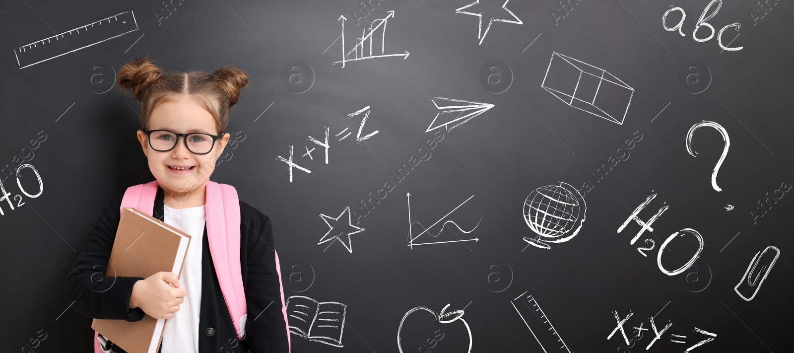 Image of School girl holding notebook near blackboard with chalk drawings and inscriptions, banner design