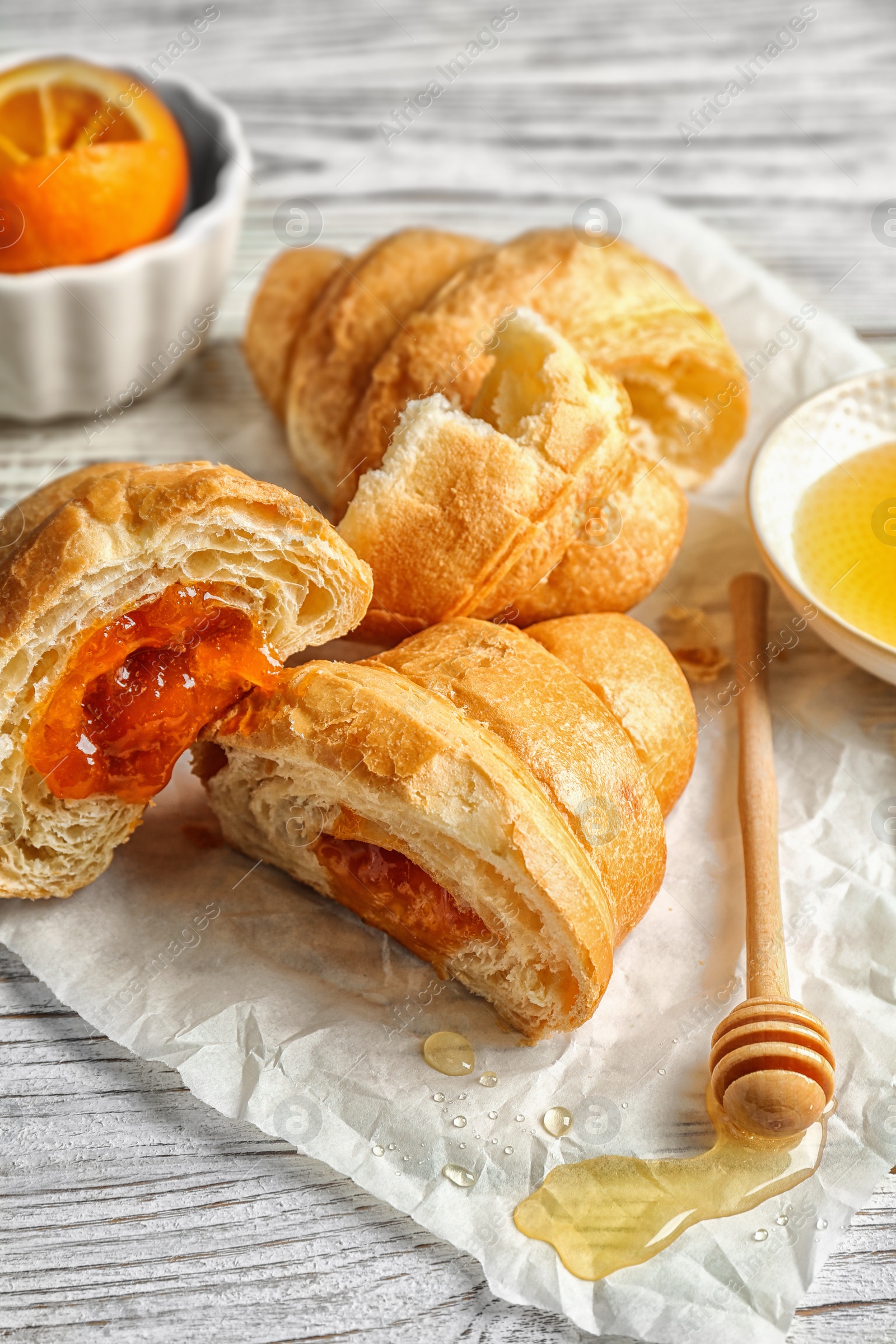 Photo of Tasty croissants served for breakfast on wooden table