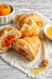 Tasty croissants served for breakfast on wooden table