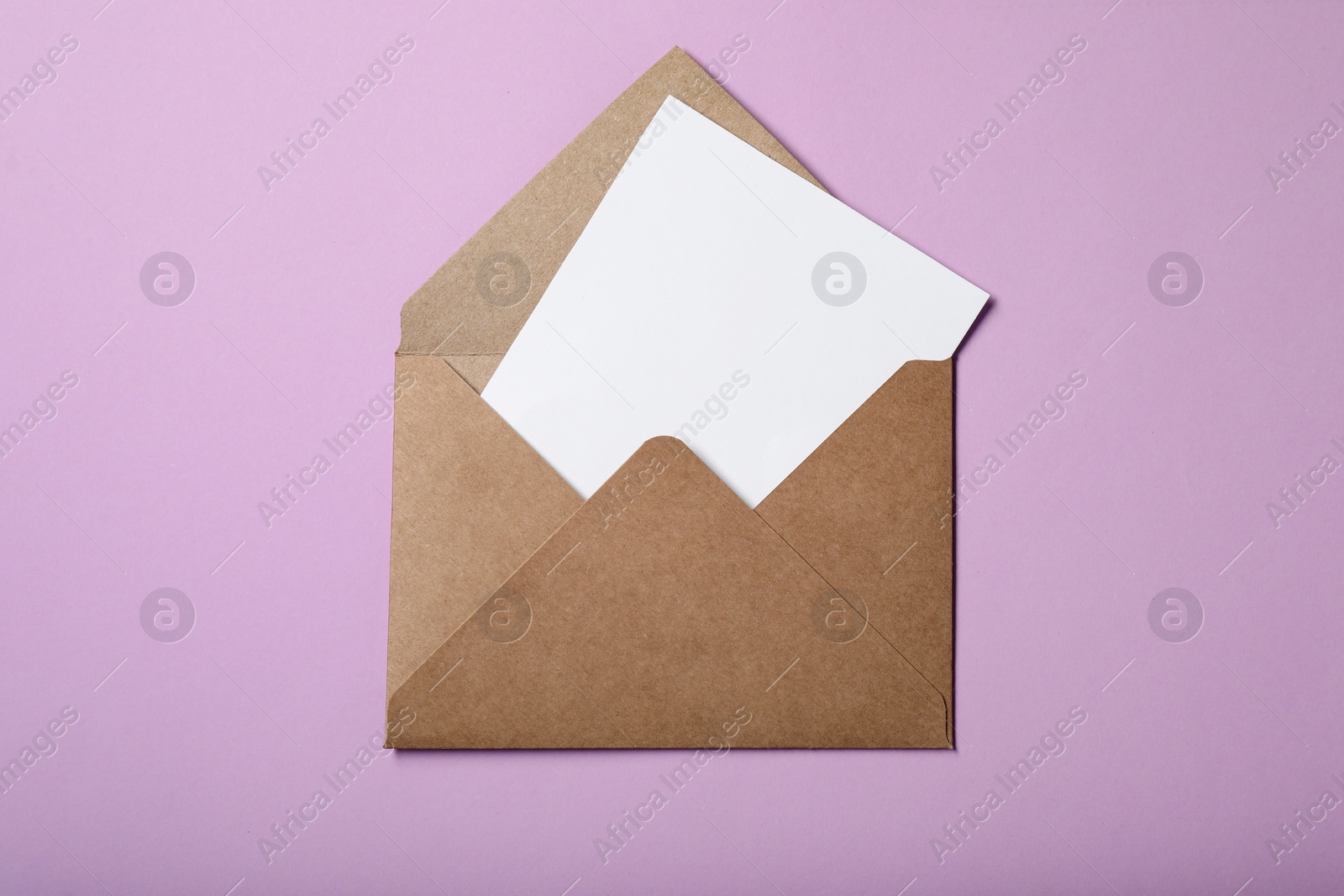 Photo of Letter envelope with card on violet background, top view