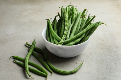 Fresh green beans on light grey table