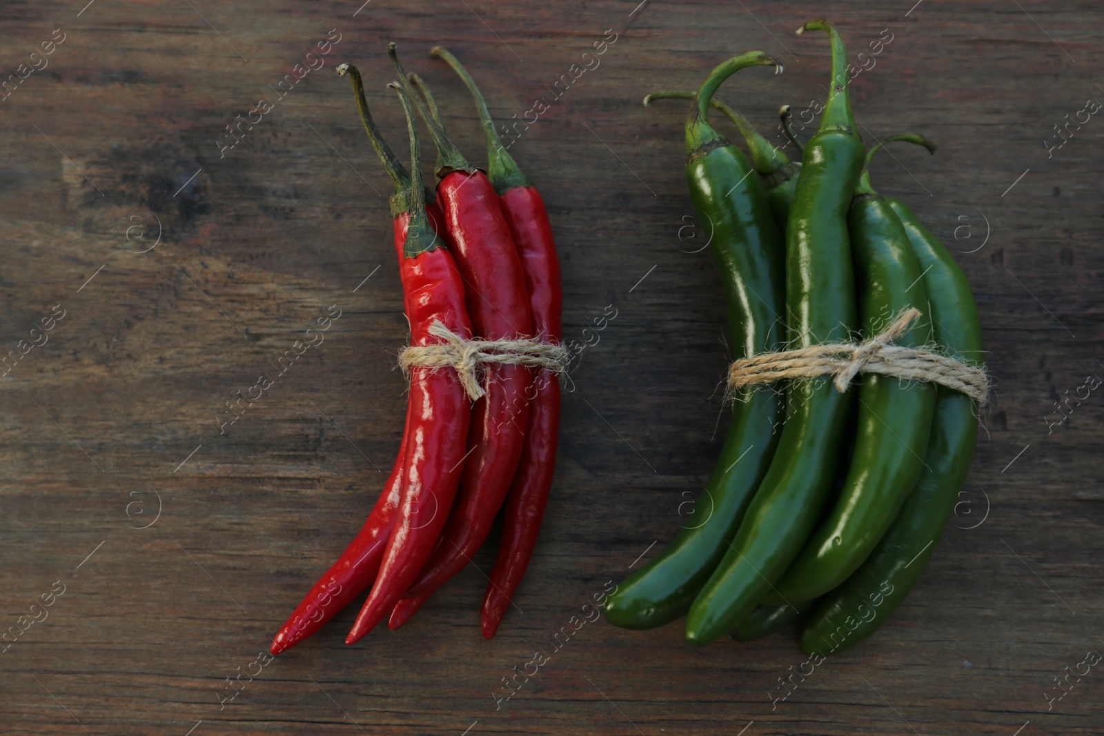 Photo of Different fresh ripe peppers on wooden table, flat lay