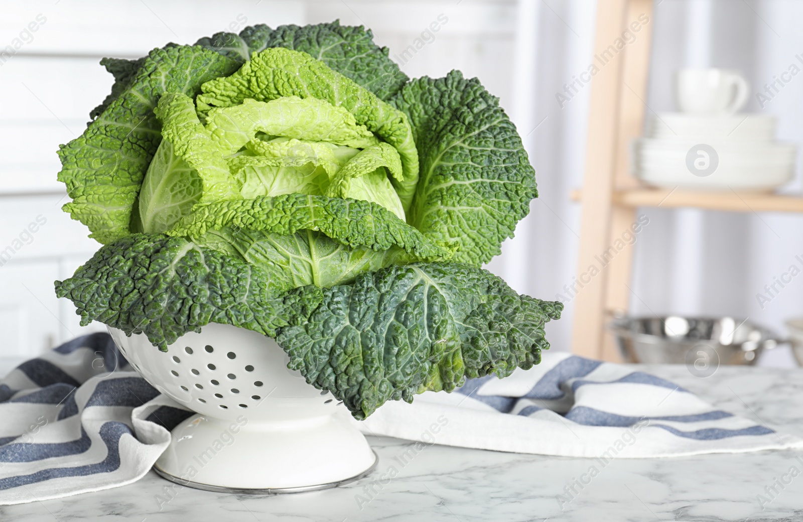 Photo of Fresh green savoy cabbage on white marble table