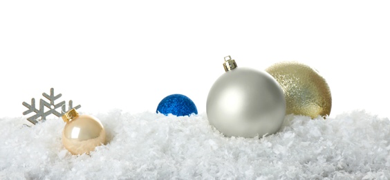 Photo of Christmas decoration on snow against white background