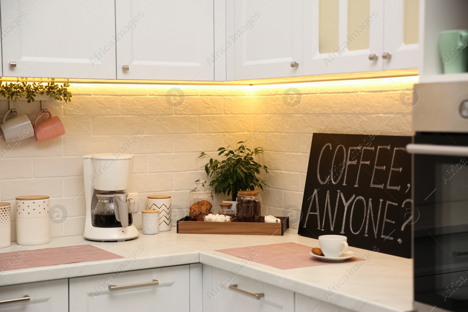 Photo of Stylish kitchen interior with modern coffeemaker on countertop