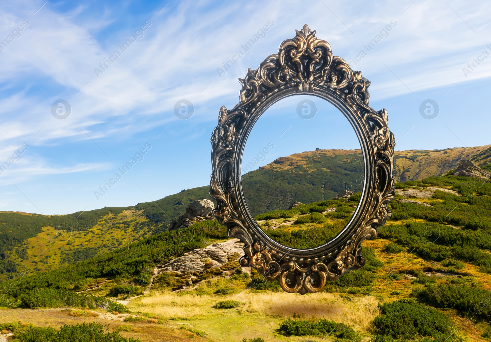 Image of Vintage frame and beautiful mountains under blue sky with clouds