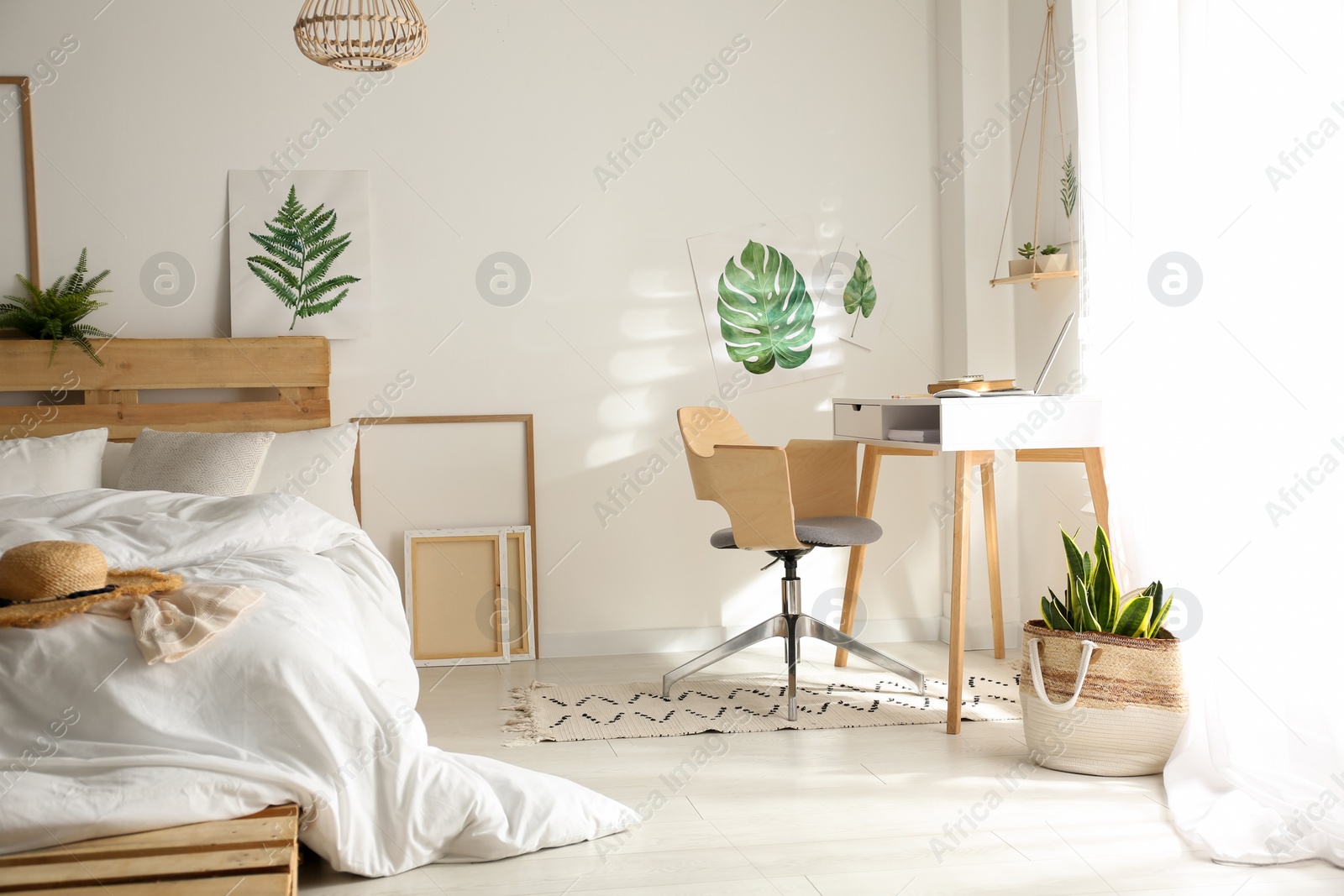 Photo of Stylish room interior with workplace and bed