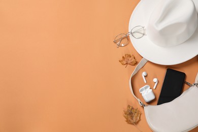 Photo of Flat lay composition with stylish hat on orange  background, space for text
