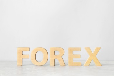 Photo of Word Forex made with wooden letters on white table